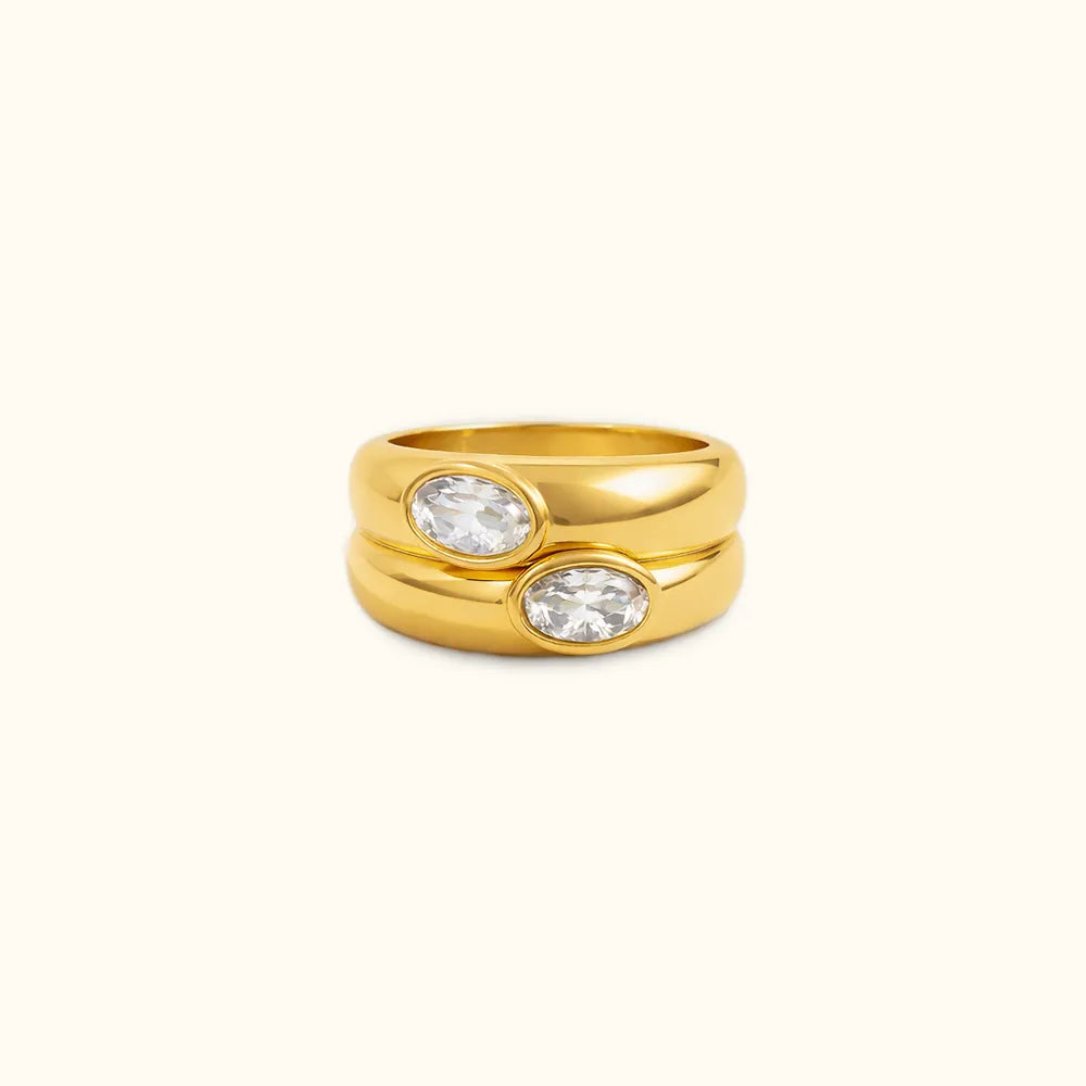 Chunky stackable double gold band ring with two clear gemstones.