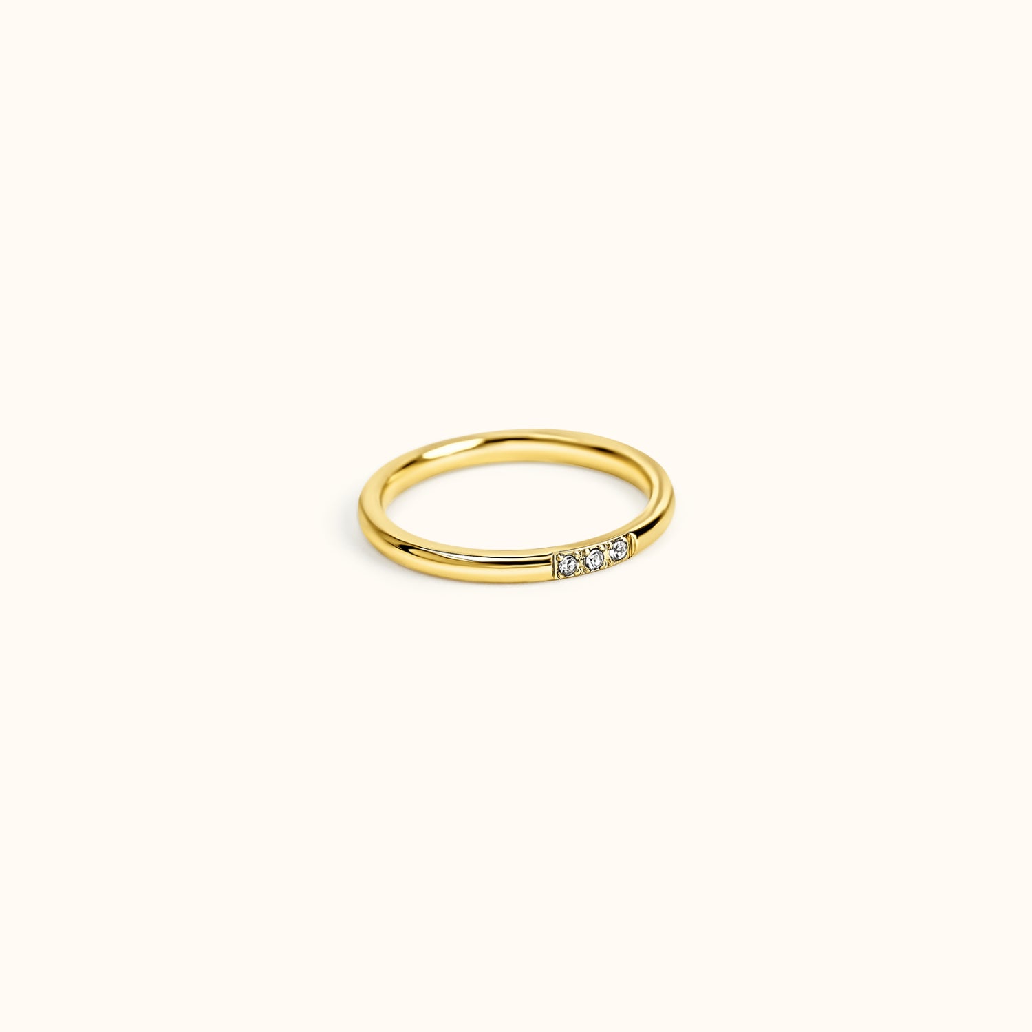 Gold ring with small diamonds on a white background